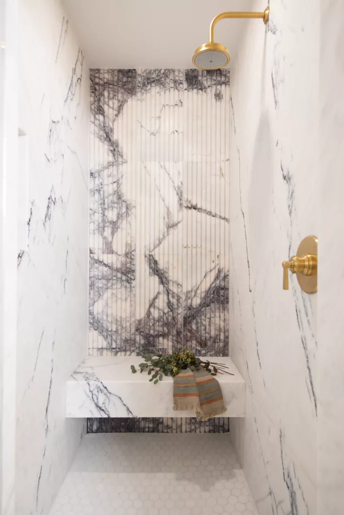 pasadena showcase house primary bathroom suite shower marble lilac grooved tile brass shower marble bench